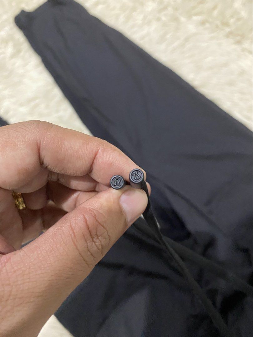Lululemon Black Athletic Pants Drawstring Size 2 (Category: Joggers) located in Manila. Submitted by switchcity (Listing ID 1466731506, Image 3). Description: - Brand: Lululemon - Size: 2 - Color: Black - Features: Drawstring waist with branded metal aglets, textured fabric, side pockets, and a subtle reflective logo - Condition: Great piece, ideal for workouts or casual wear.