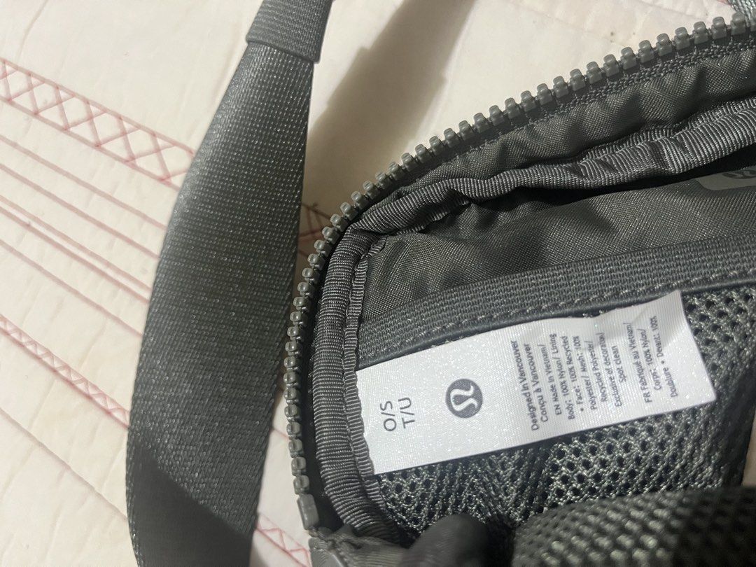 Lululemon Everywhere Belt Bag (Category: Belt bags, Clutches and Pouches) located in Manila. Submitted by lucky.beyaaa (Listing ID 1466705255, Image 3). Description: - Brand: Lululemon - Color: olive green - Features: Adjustable strap with elastic keeper, main zip compartment, interior mesh pockets, and classic logo patch - Condition: Excellent, clean interior and exterior .