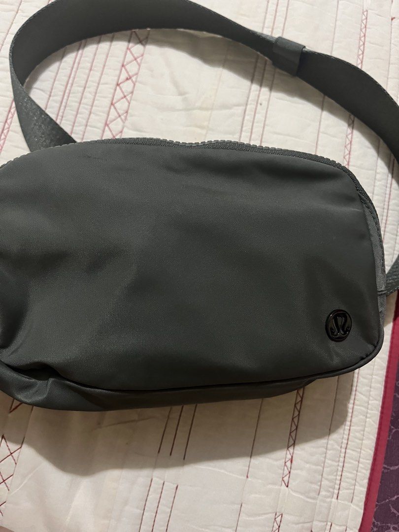 Lululemon Everywhere Belt Bag (Category: Belt bags, Clutches and Pouches) located in Manila. Submitted by lucky.beyaaa (Listing ID 1466705255, Image 2). Description: - Brand: Lululemon - Color: olive green - Features: Adjustable strap with elastic keeper, main zip compartment, interior mesh pockets, and classic logo patch - Condition: Excellent, clean interior and exterior .