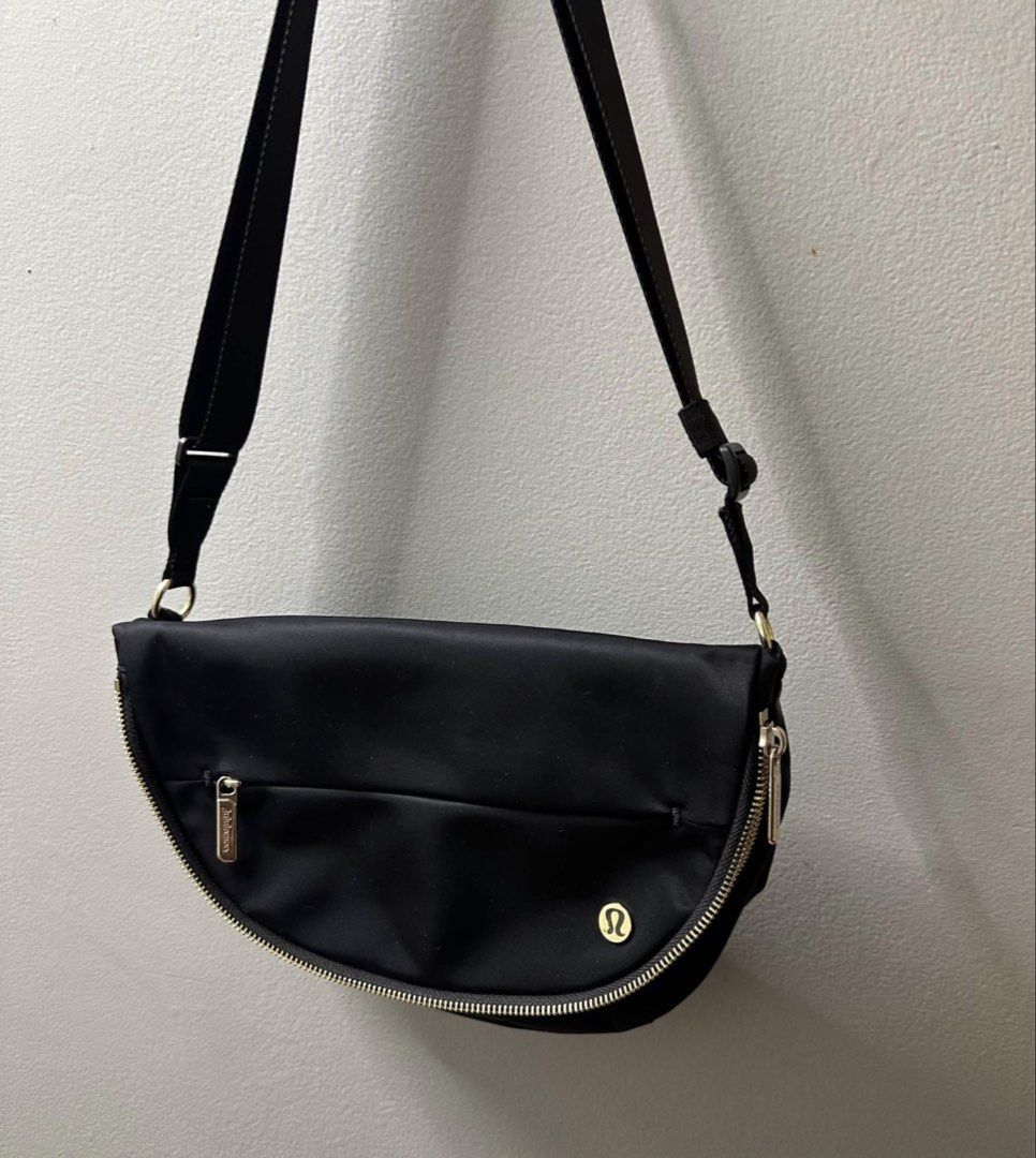 Lululemon Festival Bag (Category: Cross-body Bags) located in Anao. Submitted by declutterwithme0520 (Listing ID 1466585397, Image 3). Description: eta October 26 Good as new - Brand: Lululemon - Color: Classic Black with premium gold hardware - Style: Curved half-moon crossbody bag - Features: Secure top flap and handy exterior zipper pocket - Strap: Adjustable for a custom fit - Condition: Clean interior lining - Ideal for: Everyday errands, ca