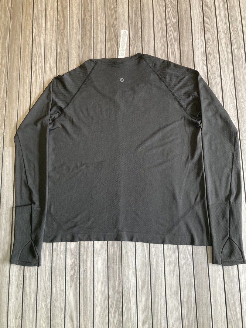 Lululemon Long Sleeve Athletic Top Size 14 (Category: Longsleeves) located in Trece Martires City. Submitted by thriftkoto.91 (Listing ID 1466564496, Image 3). Description: - Brand: Lululemon - Color: Dark Grey - Size: 14 - Material: Comfortable seamless fabric with ribbed detailing on sleeves and hem - Features: Practical thumbholes at the cuffs and a small reflective logo on the upper back - Condition: Great for workouts and everyday activewear