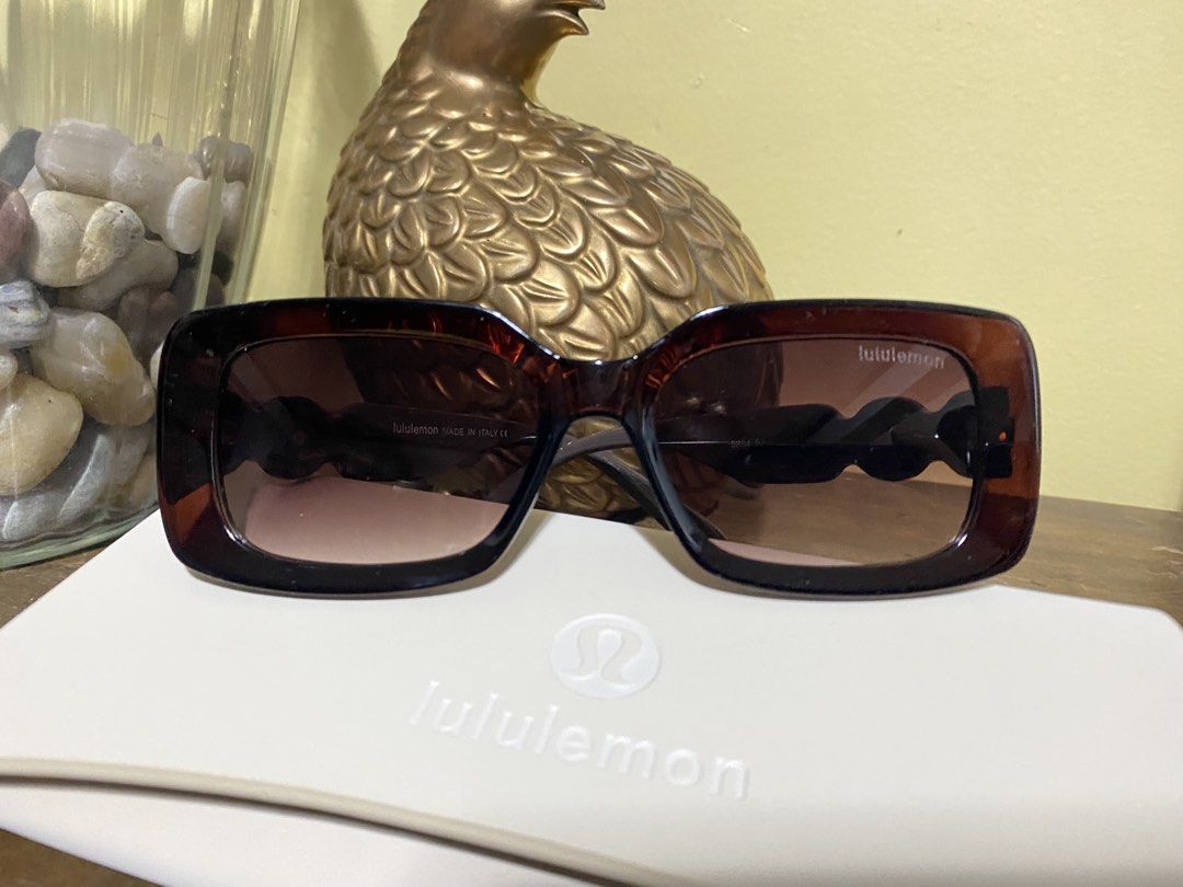 Lululemon Tortoiseshell Sunglasses with Case (Category: Sunglasses & Eyewear) located in Baguio. Submitted by SweetRepeat (Listing ID 1466624276, Image 1). Description: Lululemon sunglasses in a classic tortoiseshell brown frame. Gradient lenses with subtle branding on the upper corner. Temples feature the iconic lululemon wordmark and logo hardware in gold-tone metal. Made in Italy. Includes the original cream-colored hard case with debossed log