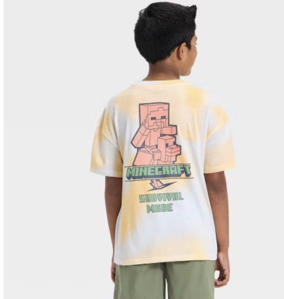 Mad Engine Minecraft T-Shirt Large (Category: Babies & Kids Fashion) located in Paranaque City. Submitted by PrelovedClosetetc (Listing ID 1466573581, Image 2). Description: - Brand new with original store tags - Official Mad Engine Minecraft merchandise - Unique yellow and white tie-dye wash effect - Cute chicken design on the front chest - Bold 'Survival Mode' graphic print on the back - Comfortable short sleeves with a classic crew neck - Mate