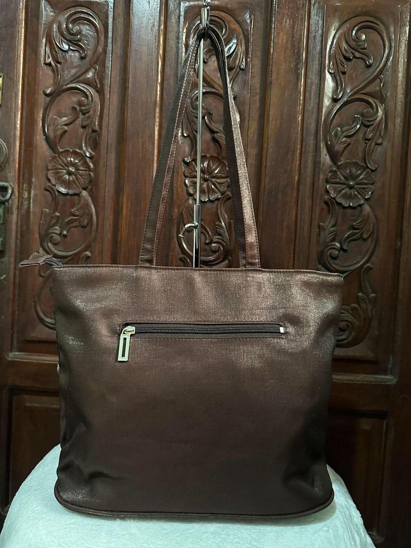 Mango Accessories Collection Brown Tote Bag (Category: Tote Bags) located in Pasacao. Submitted by kishhuschka (Listing ID 1466652468, Image 2). Description: Mango Accessories Collection tote bag in metallic brown. Mixed texture design combining metallic panels, animal print sections, and decorative cross-stitching. Dual shoulder straps for carrying. Rear zippered pocket for quick storage. Silver-tone metal brand plaque on the front. Clean lining