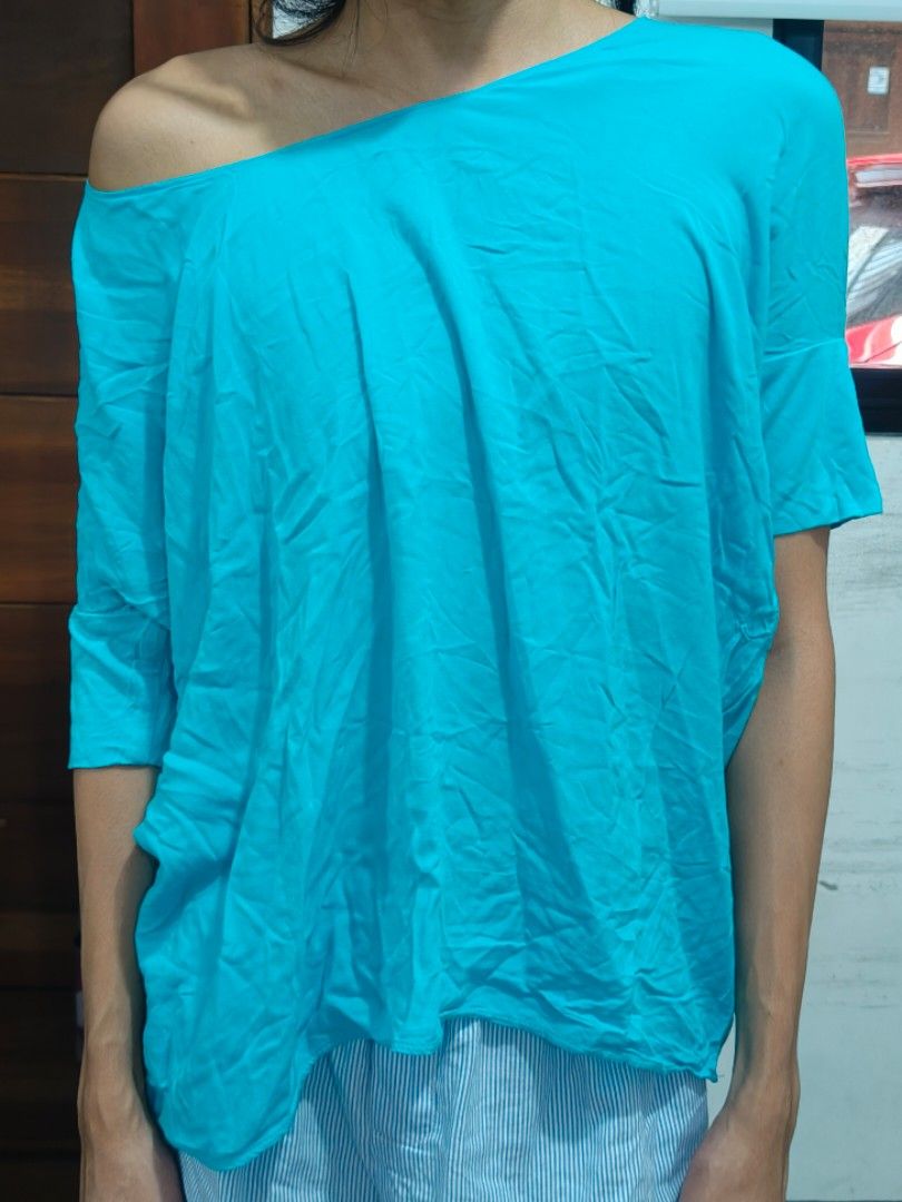 MANGO Collection Turquoise Off-Shoulder Top (Category: Blouses) located in Paranaque City. Submitted by vicibaltazar (Listing ID 1466592123, Image 3). Description: - Brand: MANGO Collection - Color: Bright turquoise - Size: EUR S, USA XS, MEX CH - Fit: Relaxed, oversized with a draped silhouette - Design: Asymmetric off-shoulder neckline with short sleeves - Material: Lightweight and easy to style for casual outings.