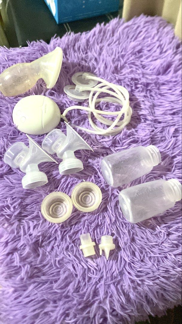 Manual Electric Breast Pump w/ Manual Pump (Category: Breastfeeding & Bottle Feeding) located in Quezon City. Submitted by macastillo1998 (Listing ID 1466591110, Image 1). Description: Real Bubee electric breast pump unit in white. Includes motor unit, tubing, two collection bottles, breast shields, duckbill valves, and silicone diaphragms. Compact dual pump setup for expressing milk at home or away. All parts clean and laid out clearly. Handy se