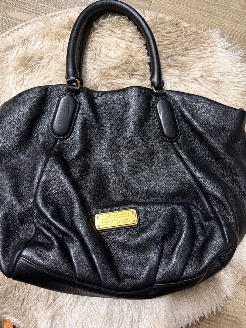 Marc by Marc Jacobs Black Leather Workwear Handbag (Category: Luxury Bags & Wallets) located in Quezon City. Submitted by rosell.xoxo (Listing ID 1466687042, Image 1). Description: Black textured leather handbag by Marc by Marc Jacobs, Standard Supply line, Workwear model. Gold hardware plaque on the front. Double top handles plus an adjustable, detachable shoulder strap. Magnetic snap closure. - Lighly used.