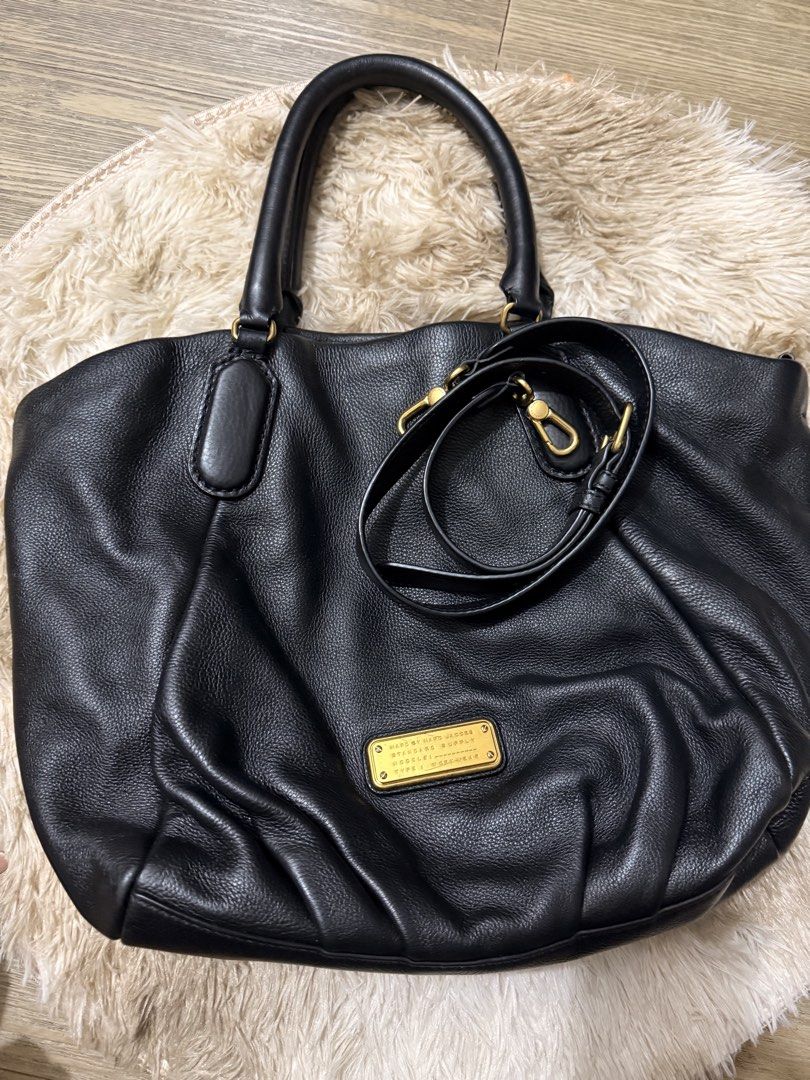 Marc by Marc Jacobs Black Leather Workwear Handbag (Category: Luxury Bags & Wallets) located in Quezon City. Submitted by rosell.xoxo (Listing ID 1466687042, Image 2). Description: Black textured leather handbag by Marc by Marc Jacobs, Standard Supply line, Workwear model. Gold hardware plaque on the front. Double top handles plus an adjustable, detachable shoulder strap. Magnetic snap closure. - Lighly used.