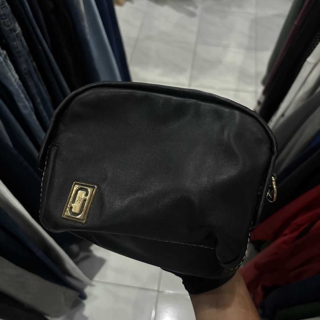 Marc Jacob sling Bag with Gold Hardware (Category: Cross-body Bags) located in Bambang. Submitted by heats777 (Listing ID 1466662933, Image 1). Description: - Style: Black leather crossbody bag with a structured rectangular shape - Details: Chic contrast white stitching along edges and seams - Hardware: Premium gold-toned metal logo plaque and chunky gold zipper closure - Size: Compact and lightweight, ideal for everyday carry - Condition: Lightl