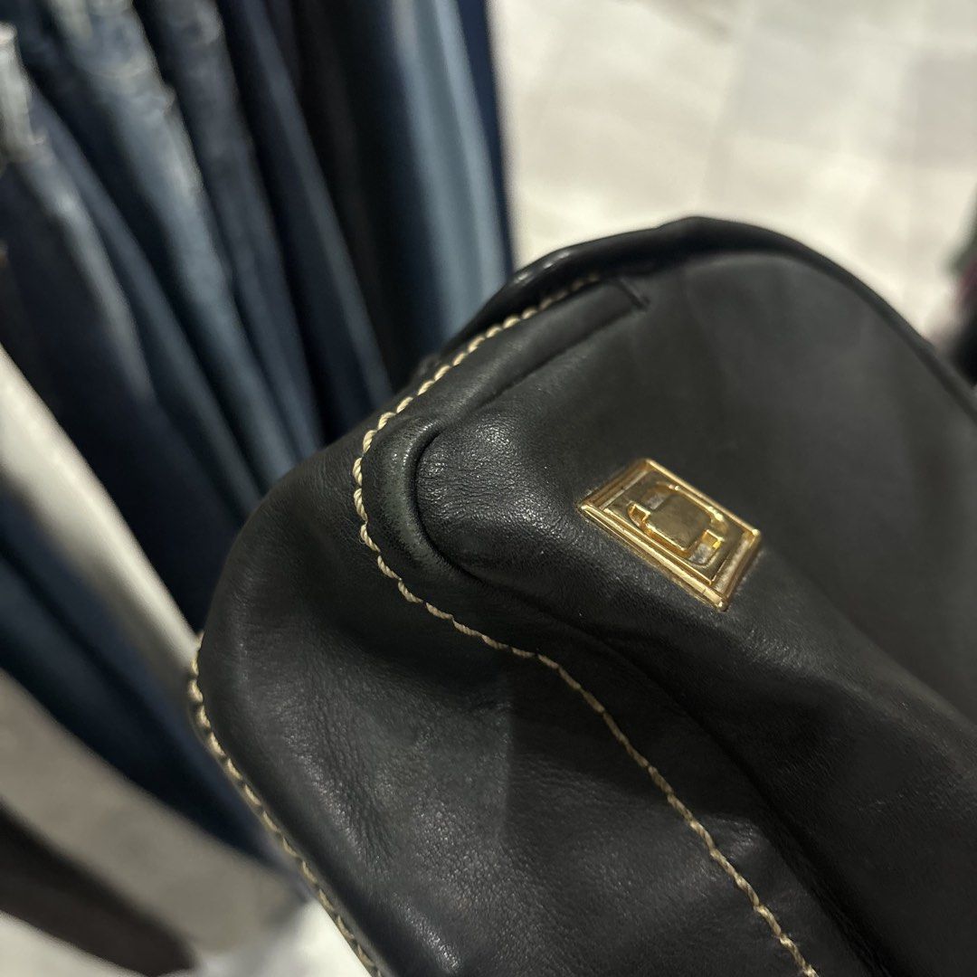 Marc Jacob sling Bag with Gold Hardware (Category: Cross-body Bags) located in Bambang. Submitted by heats777 (Listing ID 1466662933, Image 3). Description: - Style: Black leather crossbody bag with a structured rectangular shape - Details: Chic contrast white stitching along edges and seams - Hardware: Premium gold-toned metal logo plaque and chunky gold zipper closure - Size: Compact and lightweight, ideal for everyday carry - Condition: Lightl