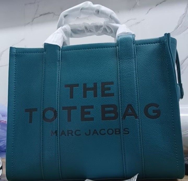 Marc Jacobs Leather Tote Bag (Category: Tote Bags) located in Pasig City. Submitted by jkeeei (Listing ID 1466663966, Image 1). Description: - Brand: Marc Jacobs - Style: Leather Tote Bag - Color: harbor blue and Apple Green - Condition: Used Once - Rationale for selling: Decluttering closet 2 bags for 7,499 only.
