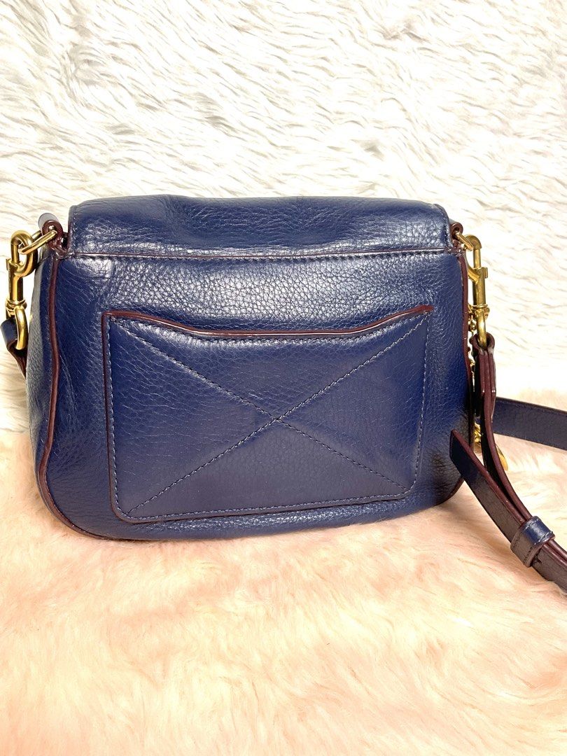 Marc Jacobs Navy Blue Leather Crossbody Bag (Category: Cross-body Bags) located in La Trinidad. Submitted by naravincollections (Listing ID 1466651337, Image 2). Description: Dark blue pebbled leather Marc Jacobs crossbody bag with gold hardware. Zippered pocket on the front flap plus another pocket on the back. Adjustable and detachable shoulder strap with metal clips. Fabric lining inside with magnetic closure. Leather zipper pulls and metal lo