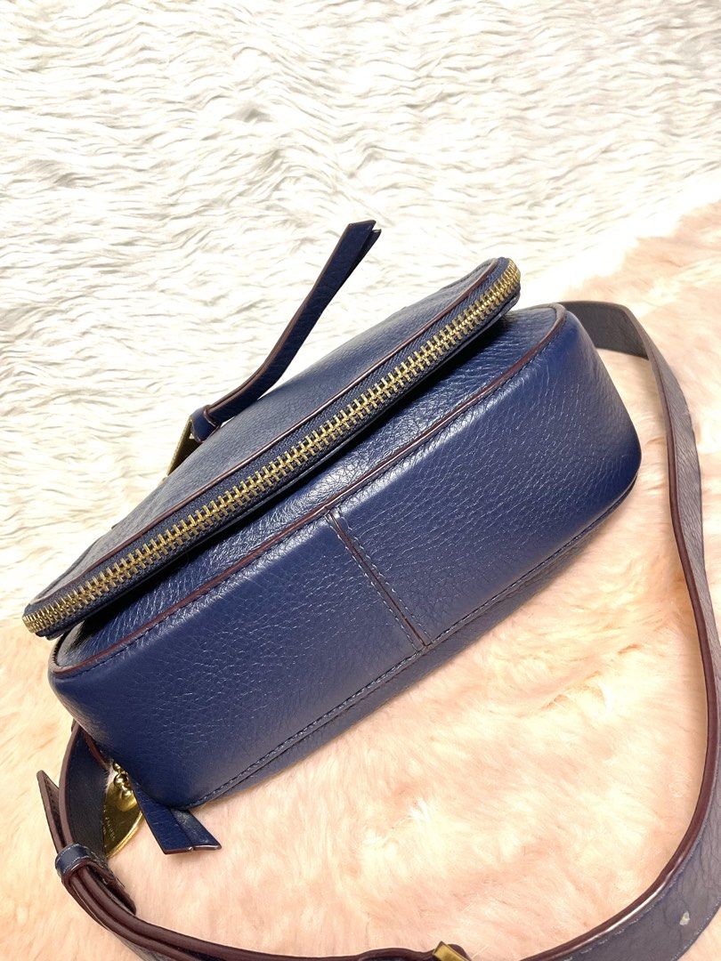 Marc Jacobs Navy Blue Leather Crossbody Bag (Category: Cross-body Bags) located in La Trinidad. Submitted by naravincollections (Listing ID 1466651337, Image 3). Description: Dark blue pebbled leather Marc Jacobs crossbody bag with gold hardware. Zippered pocket on the front flap plus another pocket on the back. Adjustable and detachable shoulder strap with metal clips. Fabric lining inside with magnetic closure. Leather zipper pulls and metal lo