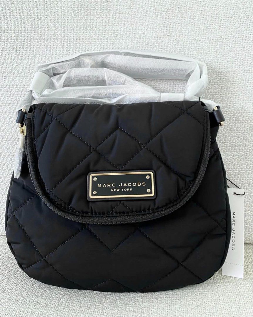 Marc Jacobs Quilted Nylon Crossbody Bag Black (Category: Cross-body Bags) located in Abulug. Submitted by jamiecammie (Listing ID 1466700809, Image 1). Description: Marc Jacobs quilted nylon crossbody bag in classic black. Front flap closure with gold-tone hardware and signature logo plaque. Zippered main compartment, interior zip pocket. Adjustable strap wrapped in protective packaging, original store tags attached. Never used, pristine conditio