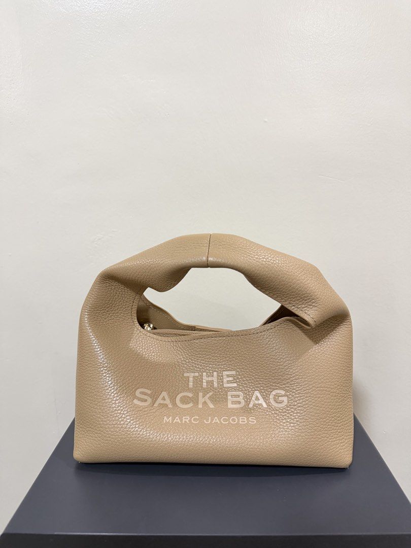 Marc Jacobs The Mini Sack Bag Camel (Category: Luxury Bags & Wallets) located in Marikina City. Submitted by denisekasscarlos (Listing ID 1466596442, Image 2). Description: - Brand: Marc Jacobs - Style: The Mini Sack Bag - Color: Camel - Material: Premium pebble leather - Details: Debossed logo on front, patch on back, top handle, zipper closure - Inclusions: Original dust bag, tags, and care cards .