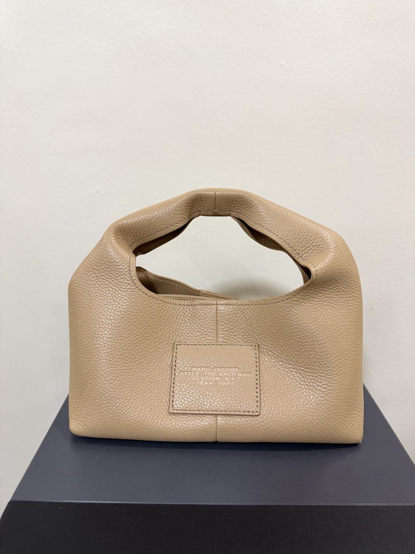 Marc Jacobs The Mini Sack Bag Camel (Category: Luxury Bags & Wallets) located in Marikina City. Submitted by denisekasscarlos (Listing ID 1466596442, Image 3). Description: - Brand: Marc Jacobs - Style: The Mini Sack Bag - Color: Camel - Material: Premium pebble leather - Details: Debossed logo on front, patch on back, top handle, zipper closure - Inclusions: Original dust bag, tags, and care cards .