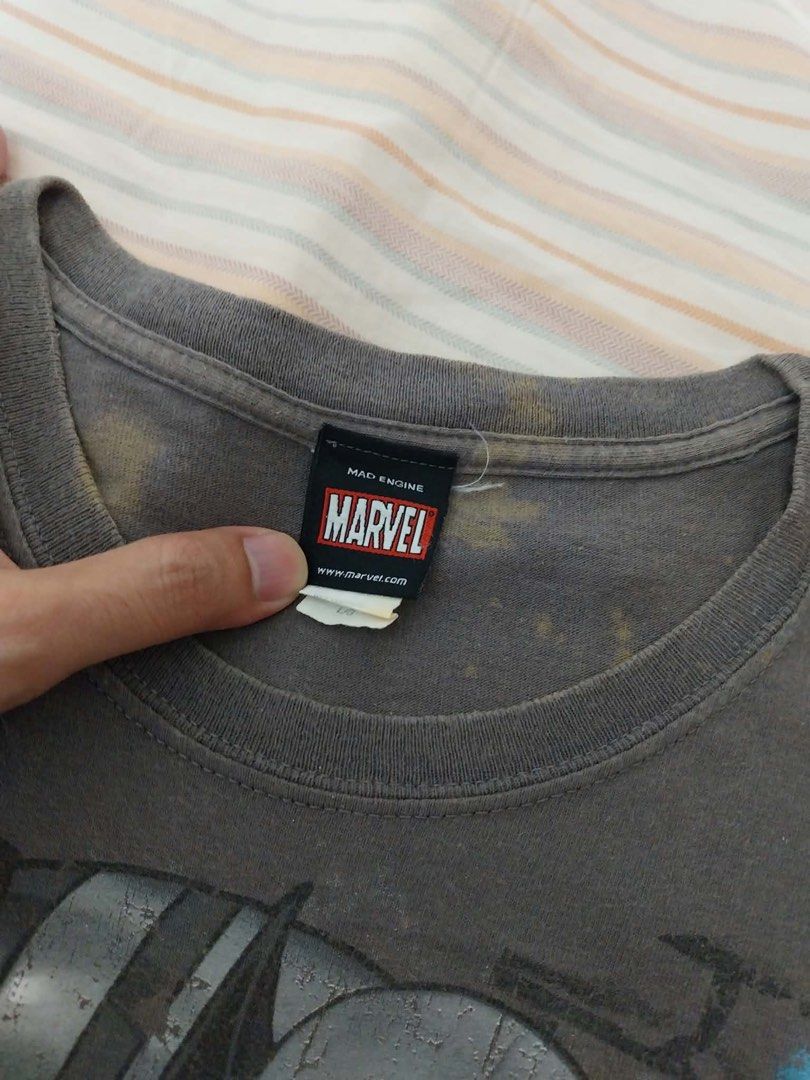 Marvel Mad Engine Wolverine Graphic T-Shirt Grey (Category: Tshirts & Polo Shirts ) located in Manila. Submitted by melcauton (Listing ID 1466576119, Image 2). Description: - Brand: Official Marvel Mad Engine - Design: Large Wolverine mid-action graphic print on the front - Style: Short sleeves, classic crew neck - Color: Grey - Condition: Noticeable discoloration and staining around the collar area from age/storage - Perfect casual tee for Marve