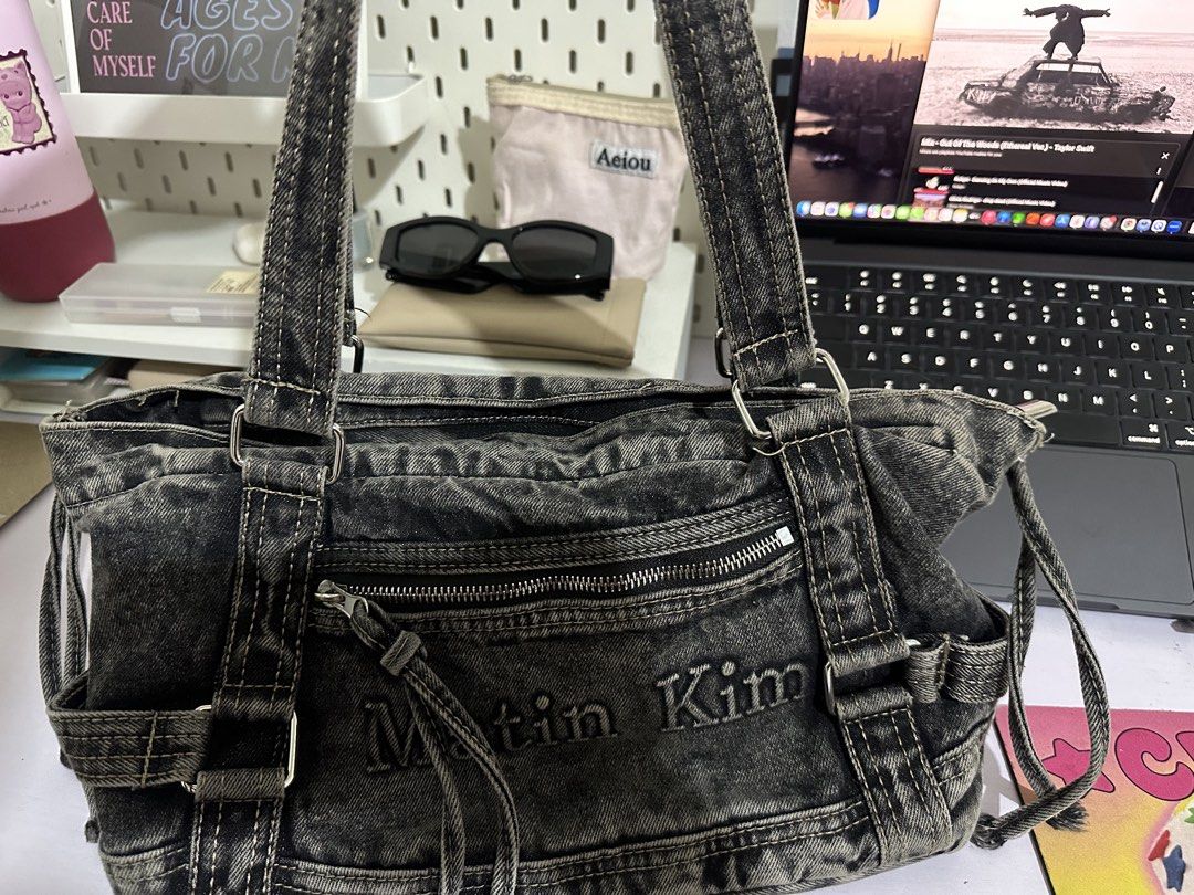 Matin Kim denim shoulder bag tote (Category: Shoulder Bags) located in Legazpi City. Submitted by loveagainz (Listing ID 1466412889, Image 2). Description: - Brand: Matin Kim D00P only from orange app - Style: Denim shoulder bag, tote w/zipper - Finish: Acid wash dark denim with light fading - Details: Front pocket with logo lettering, dual shoulder straps, and side drawstrings - Capacity: Very spacious, perfect for daily essentials - Condition: 