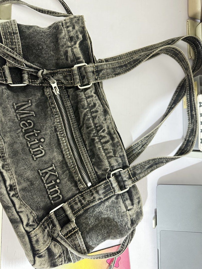Matin Kim denim shoulder bag tote (Category: Shoulder Bags) located in Legazpi City. Submitted by loveagainz (Listing ID 1466412889, Image 1). Description: - Brand: Matin Kim D00P only from orange app - Style: Denim shoulder bag, tote w/zipper - Finish: Acid wash dark denim with light fading - Details: Front pocket with logo lettering, dual shoulder straps, and side drawstrings - Capacity: Very spacious, perfect for daily essentials - Condition: 