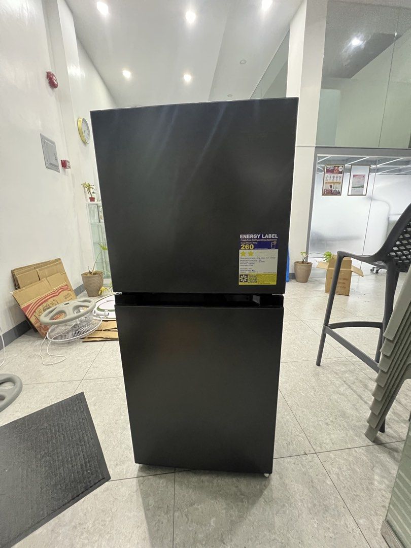 Maxi double door refrigerator with energy label (Category: Refrigerators and Freezers) located in Pasay City. Submitted by katkat143 (Listing ID 1466744380, Image 2). Description: - Brand/Model: Maxi Double Door Refrigerator - Color: Black exterior with clean white interior - Energy Efficiency: Energy label rating 260 - Fridge Features: Adjustable glass shelves, door bins, and bottom crisper drawer - Freezer Features: Built-in shelf and convenien