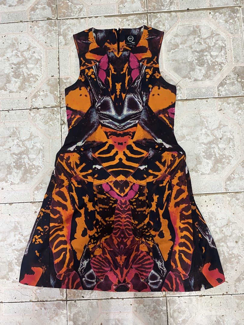 McQ Alexander McQueen sleeveless patterned dress IT 36 (Category: Dresses) located in Iloilo. Submitted by dripnest.ilo (Listing ID 1466734137, Image 1). Description: - Brand: McQ Alexander McQueen - Style: Sleeveless dress with a round neckline and back zipper closure - Design: Striking multicolored abstract print in shades of orange, pink, and dark blue - Size: Italian size 36 (Fits true to size) - Origin: Made in Italy - Care: Professional dry