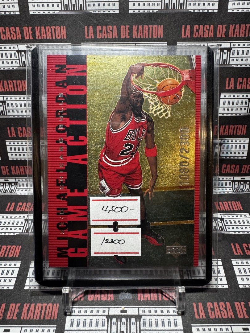 Michael Jordan (Category: Raw Singles) located in Pateros City. Submitted by lacasadekartonph (Listing ID 1466690150, Image 1). Description: - Player: Michael Jordan in iconic Chicago Bulls red jersey - Brand/Series: Upper Deck Game Action trading card - Rarity: Limited edition, gold stamped #1080 out of 2300 on the front - Design: Stunning gold foil background with a vertical red stripe and black text - Condition/Protection: Comes securely store