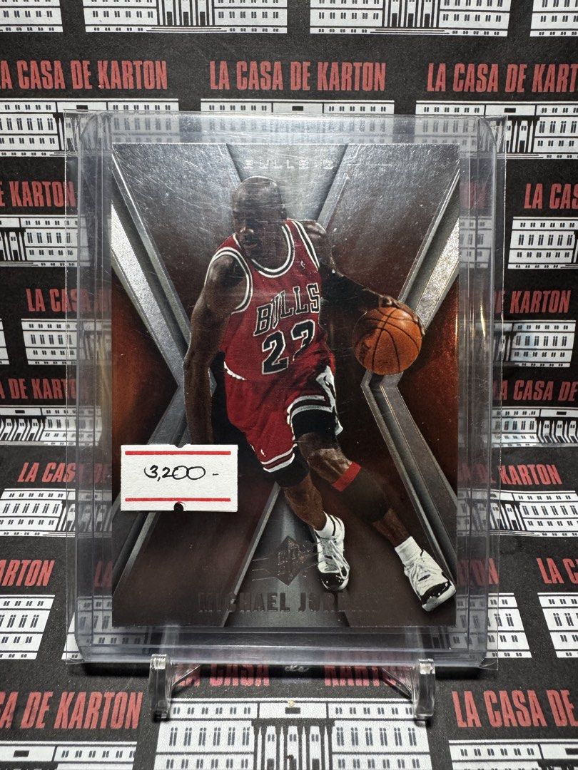 Michael Jordan (Category: Raw Singles) located in Pateros City. Submitted by lacasadekartonph (Listing ID 1466694022, Image 1). Description: - Player: Michael Jordan (Chicago Bulls) - Set: Upper Deck X - Design: Action shot driving past defenders in his red jersey - Protection: Comes in a hard plastic top loader - Condition: Great collectible piece for basketball fans and Jordan supporters.