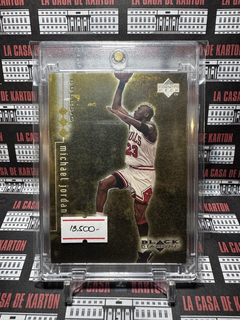 Michael Jordan (Category: Raw Singles) located in Pateros City. Submitted by lacasadekartonph (Listing ID 1466695154, Image 1). Description: - Player: Michael Jordan (Chicago Bulls) - Brand: Upper Deck Black Diamond - Design: Gold background with diamond icons - Condition: Protected inside a clear magnetic hard case - Perfect for collectors and fans.