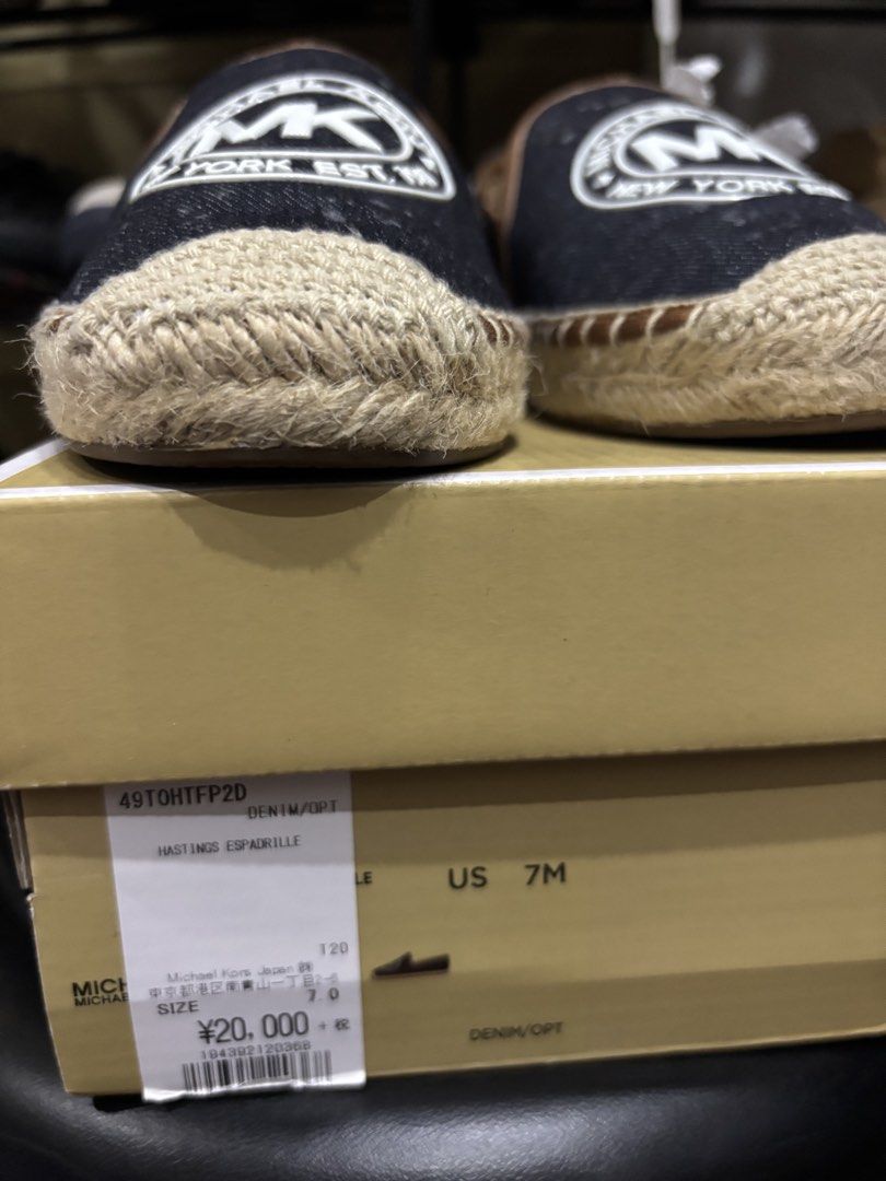 Michael Kors Hastings Espadrilles Denim Size 7M (Category: Flats & Sandals) located in Malabon City. Submitted by everythingpreloveddd (Listing ID 1466722917, Image 2). Description: - Brand: Michael Kors Hastings - Style: Slip-on espadrilles with jute-wrapped sole - Color/Design: Dark denim upper, brown trim, and large white MK logo patch - Size: US 7M - Condition: Never worn, brand new in box with original tissue paper.