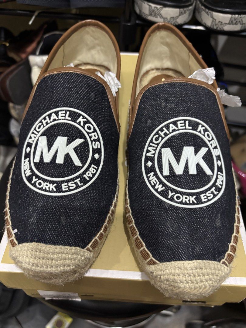 Michael Kors Hastings Espadrilles Denim Size 7M (Category: Flats & Sandals) located in Malabon City. Submitted by everythingpreloveddd (Listing ID 1466722917, Image 1). Description: - Brand: Michael Kors Hastings - Style: Slip-on espadrilles with jute-wrapped sole - Color/Design: Dark denim upper, brown trim, and large white MK logo patch - Size: US 7M - Condition: Never worn, brand new in box with original tissue paper.