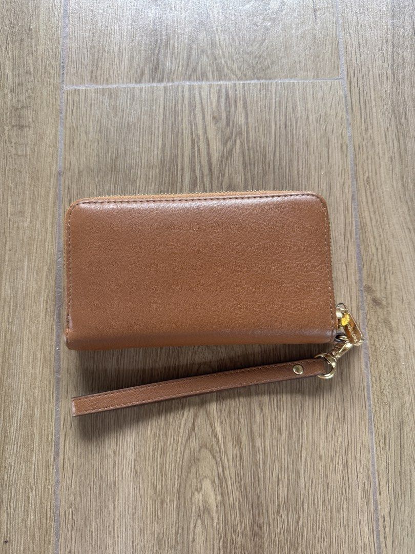 Michael Kors Phone Wallet (Category: Wallets & Card holders) located in Santa Rosa. Submitted by meldeclutters (Listing ID 1466563732, Image 2). Description: Michael Kors Phone Wallet Bought in Japan Lightly used, signs of usage Php 800 RFS: Declutter.