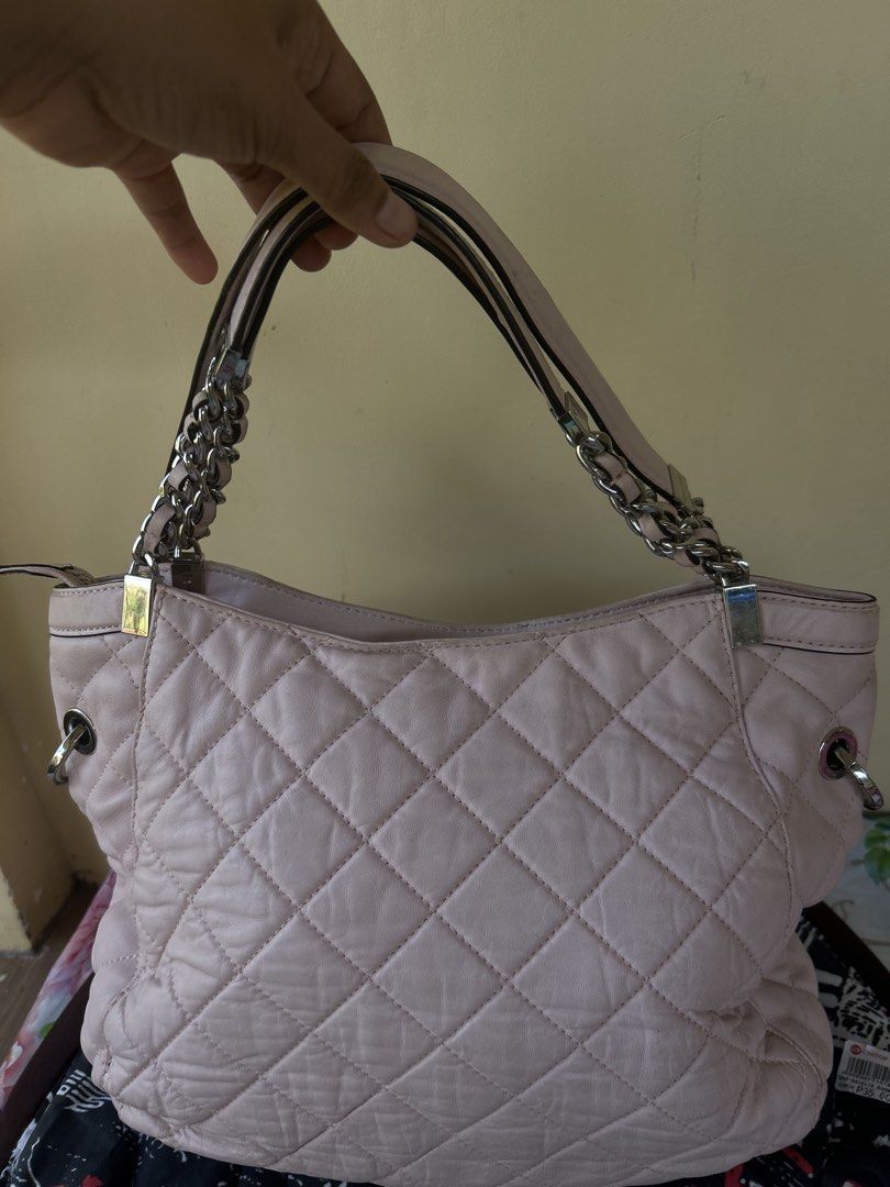 Michael Kors Quilted Pink Leather Shoulder Bag (Category: Luxury Bags & Wallets) located in Valencia. Submitted by carmzfindsph (Listing ID 1466690156, Image 3). Description: - Brand: Michael Kors - Color: Light pink with silver hardware - Material: Quilted leather - Closure: Zip top - Interior: MK logo fabric lining with slip pockets and 1 zippered pocket - Exterior: Chain straps, signature MK hanging charm, and flat structured base - Condition: