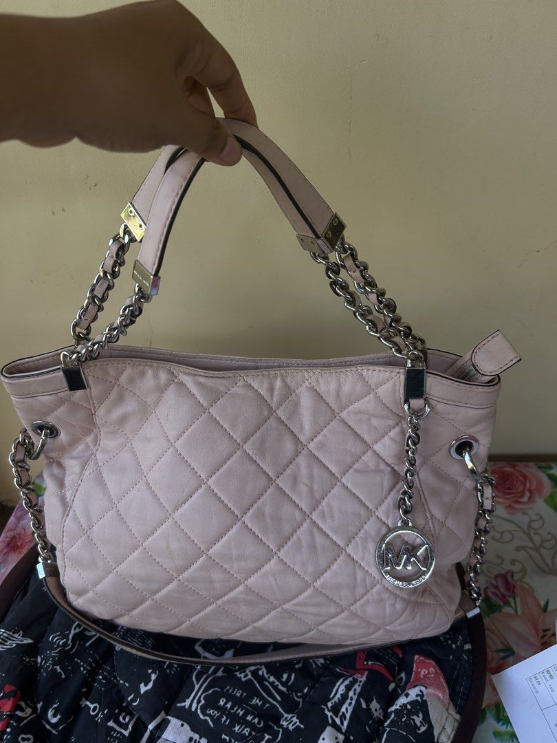 Michael Kors Quilted Pink Leather Shoulder Bag (Category: Luxury Bags & Wallets) located in Valencia. Submitted by carmzfindsph (Listing ID 1466690156, Image 1). Description: - Brand: Michael Kors - Color: Light pink with silver hardware - Material: Quilted leather - Closure: Zip top - Interior: MK logo fabric lining with slip pockets and 1 zippered pocket - Exterior: Chain straps, signature MK hanging charm, and flat structured base - Condition: