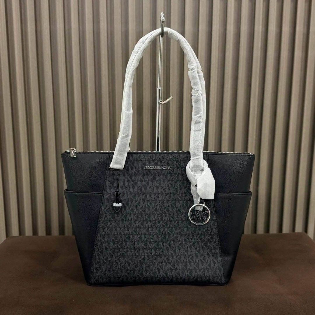 Michael Kors Tote Bag (Category: Tote Bags) located in Manila. Submitted by rhona30antiquera (Listing ID 1466574698, Image 1). Description: - Authentic Michael Kors tote bag - Colors available: Black Signature Logo, Solid Grey, and Solid Black - Structured design with dual shoulder straps (still wrapped in protective packaging) - Includes the iconic hanging MK charm logo on the side - Roomy main compartment - Perfect everyday carryall for work, s