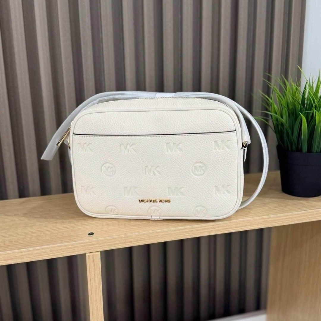 Michael Kors White Monogram Crossbody Bag (Category: Cross-body Bags) located in Manila. Submitted by rhona30antiquera (Listing ID 1466574128, Image 1). Description: - Brand: Michael Kors - Color: Pristine White.
