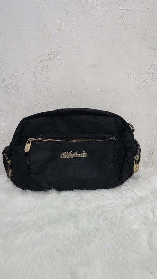 Michaela Black Sling Bag Crossbody Bag (Category: Cross-body Bags) located in Manila. Submitted by rionbenedicto (Listing ID 1466586202, Image 1). Description: - Brand: Michaela - Color: Classic Black - Material: Durable nylon - Compartments: Multiple zippered compartments for easy organization - Details: Chic gold-tone hardware and zipper pulls - Special Feature: Front zippered pocket with Michaela logo badge - Best For: Running errands or casua