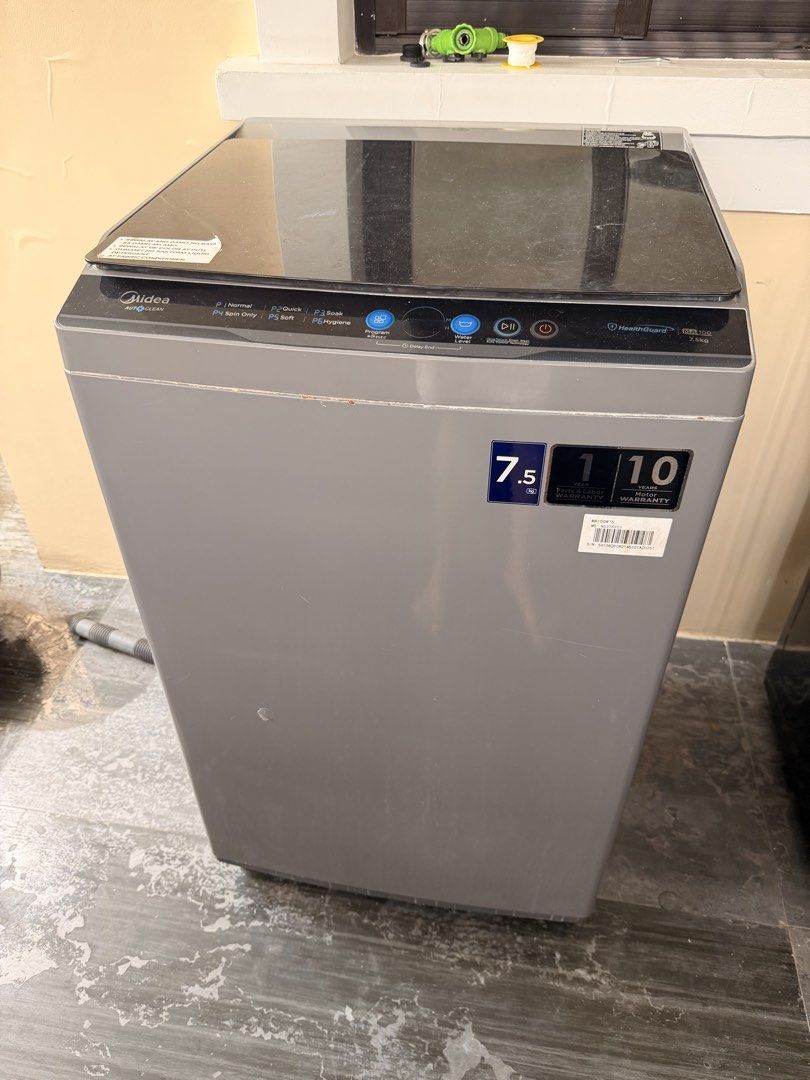 Midea MA100 7.5kg Top Load Washing Machine (Category: Washing Machines and Dryers) located in Cavite. Submitted by EmPrints (Listing ID 1466742896, Image 1). Description: - Brand: Midea - Capacity: 7.5kg top load - Color: Grey with sleek glass lid - Control Panel: Digital with programs like normal, quick, soak, hygiene, spin only, and soft - Condition: Works great for daily laundry needs - Inclusions: Comes with inlet/drainage hoses and manual in