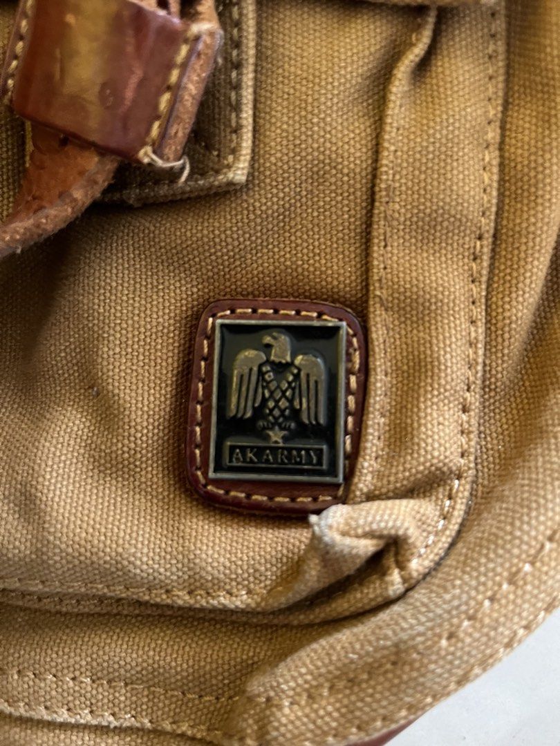 military bag (Category: Sling Bags) located in Marawi City. Submitted by fixation_05 (Listing ID 1466696181, Image 2). Description: wts akarmy brown canvas bag featuring an Akarmy logo patch with an eagle emblem. Details • Brand: Akarmy • Material: Canvas • Style: Messenger or casual utility bag w - 15.5 L - 14 excellent .