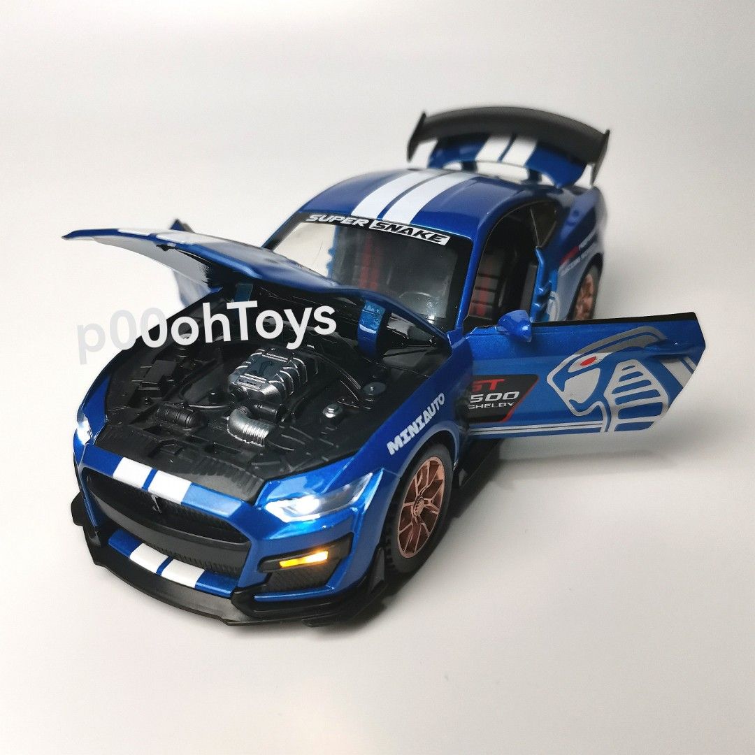 Mini Auto 1:32 Shelby Diecast Car (Category: Vehicle & Diecast Models) located in Tanza. Submitted by alloytoys (Listing ID 1466563890, Image 2). Description: - Scale: 1:32 Mini Auto Shelby GT500 Super Snake diecast model - Interactive Features: Opening hood, doors, and rear trunk with detailed interior - Lighting: Working LED headlights and taillights - Wheels & Tires: Copper-coloured alloy wheels fitted with rubber tires - Design: Custom racing