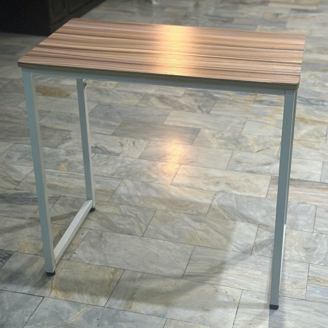 Minimalist study desk with wooden top and white frame (Category: Tables & Sets) located in Marikina City. Submitted by lovegoeson (Listing ID 1466569089, Image 2). Description: - Stylish wood grain top with clean white metal legs - Compact design, perfect for small rooms and tight corners - Sturdy steel frame ensures a wobble-free workspace - Smooth surface that is easy to wipe clean.