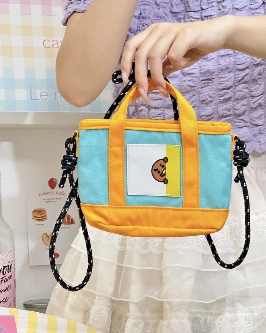 Miniso BT21 Shooky Dopamine Crossbody Bag (Category: Cross-body Bags) located in Malolos. Submitted by golden.snitch (Listing ID 1466772696, Image 2). Description: - Authentic MINISO x BT21 Shooky crossbody bag - Brand new with original tags attached - Light blue canvas body with vibrant orange handles and trim - Stylish black and white patterned rope strap with knot details - Features a cute Shooky graphic on a front white square patch - Compact