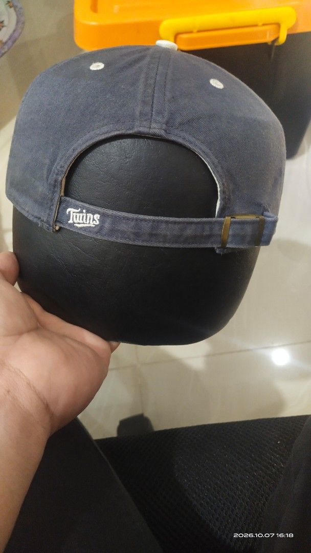 Minnesota Twins MLB Navy Blue Baseball Cap (Category: Caps & Hats) located in Manila. Submitted by rhobin.m08 (Listing ID 1466716705, Image 2). Description: - Color: Classic navy blue with a washed finish - Team: Minnesota Twins interlocking logo on the front - Details: Embroidered text on the side and back strap - Fit: Adjustable metal buckle closure for a custom fit - Interior: Contrast cream sweatband and taping - Style: Casual dad hat.