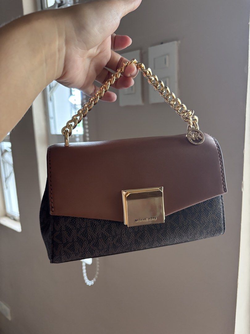 MK LITA (Category: Luxury Bags & Wallets) located in San Pablo. Submitted by aceastra (Listing ID 1466595030, Image 1). Description: - Authentic Michael Kors two-tone handbag in signature MK monogram canvas with brown leather flap - Elegant gold-tone chain top handle accented with a brand logo charm - Secure front lock clasp closure for peace of mind - Structured interior featuring multiple compartments to keep you organized - Clean lining inside