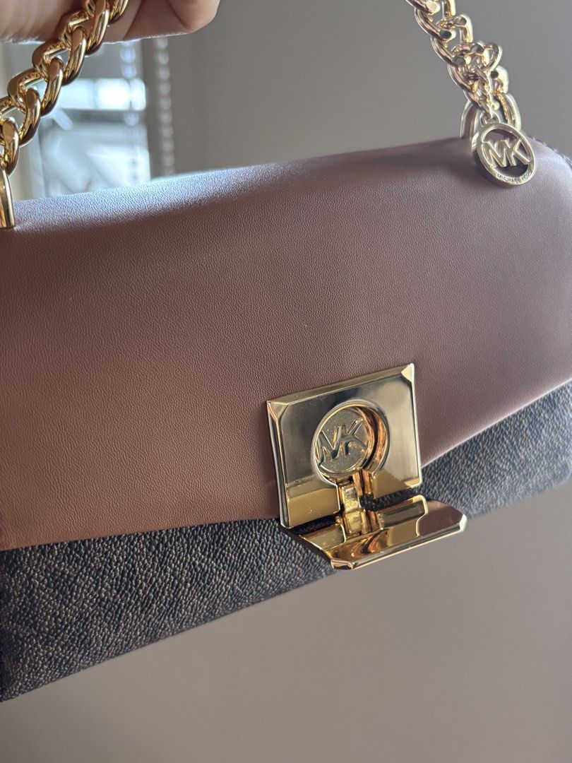 MK LITA (Category: Luxury Bags & Wallets) located in San Pablo. Submitted by aceastra (Listing ID 1466595030, Image 2). Description: - Authentic Michael Kors two-tone handbag in signature MK monogram canvas with brown leather flap - Elegant gold-tone chain top handle accented with a brand logo charm - Secure front lock clasp closure for peace of mind - Structured interior featuring multiple compartments to keep you organized - Clean lining inside