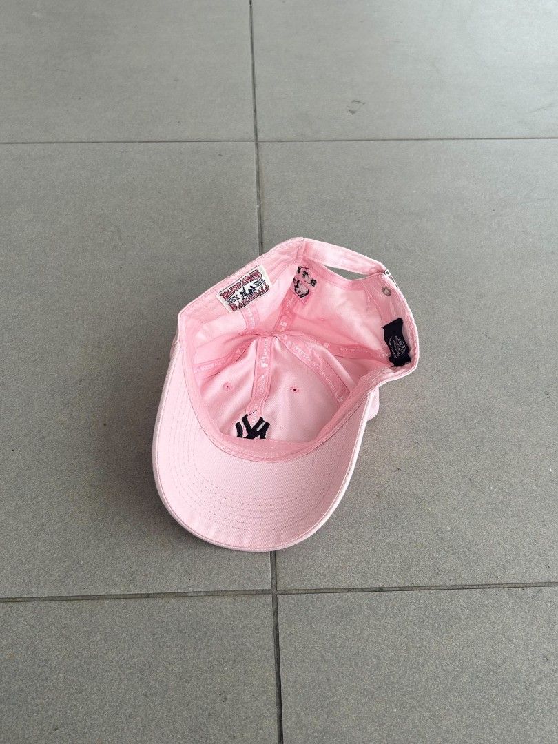 MLB New York Yankees Pink Baseball Cap (Category: Caps & Hats) located in Pasig City. Submitted by paulclzdo (Listing ID 1466639766, Image 3). Description: - Brand: MLB New York Yankees - Color: Pink with black embroidered NY logo - Material: Lightweight and breathable fabric - Fit: Adjustable back strap with silver metal buckle - Details: Features official MLB logo and clean interior taping - Condition: Brand new / Excellent everyday casual cap.