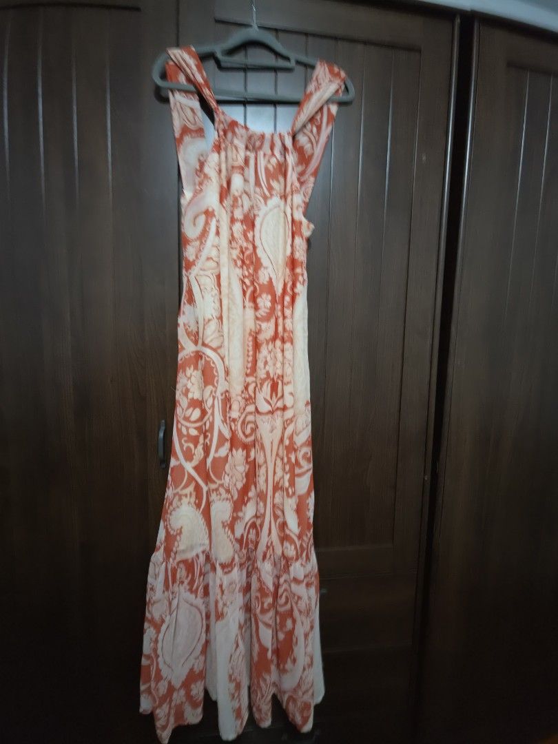 MNG Mango Red Printed Maxi Dress Size M (Category: Dresses) located in Quezon City. Submitted by sashasarisarishoppe (Listing ID 1466663149, Image 1). Description: - Brand/Style: Mango orange and cream printed maxi dress - Size: M - Material: Lightweight, flowy fabric - Design: Sleeveless with thick straps and pleated upper back detail - Best for: Warm weather, beach trips, and casual outings.