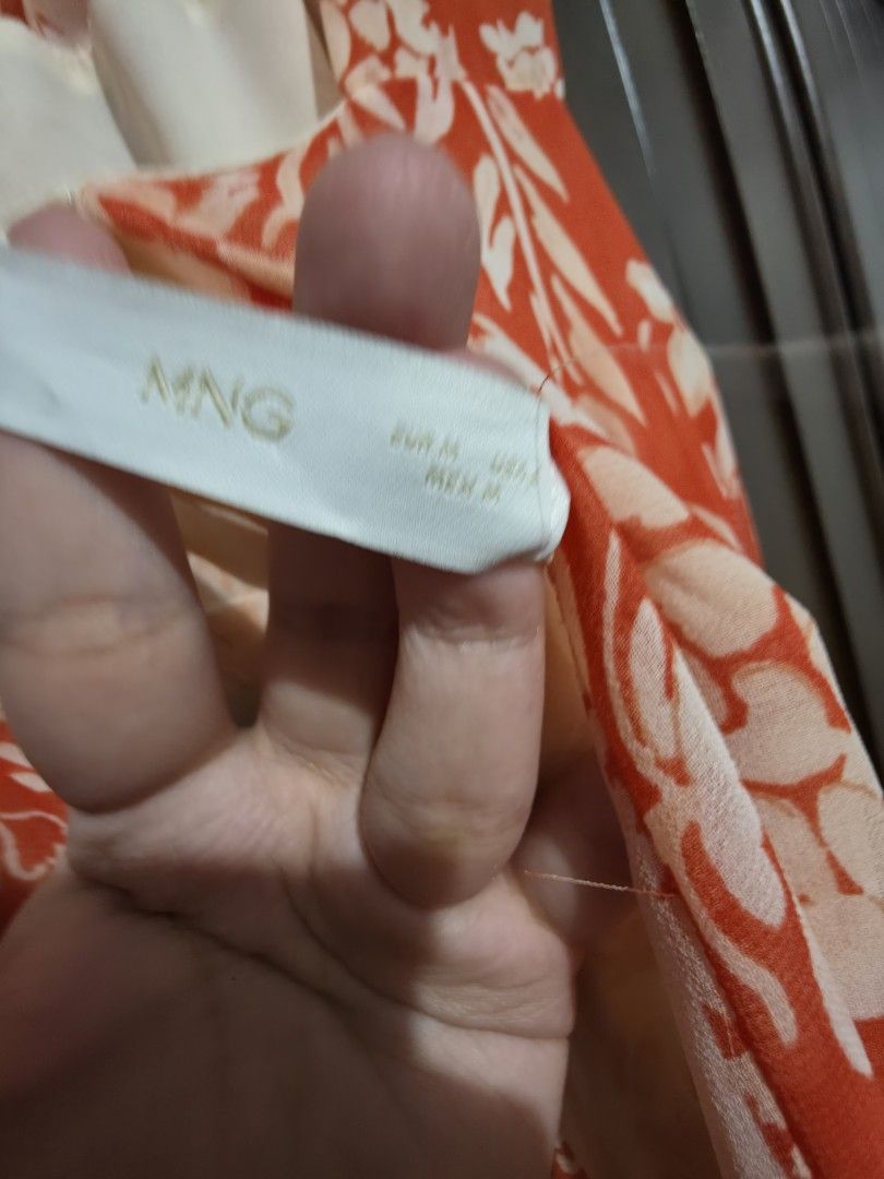 MNG Mango Red Printed Maxi Dress Size M (Category: Dresses) located in Quezon City. Submitted by sashasarisarishoppe (Listing ID 1466663149, Image 2). Description: - Brand/Style: Mango orange and cream printed maxi dress - Size: M - Material: Lightweight, flowy fabric - Design: Sleeveless with thick straps and pleated upper back detail - Best for: Warm weather, beach trips, and casual outings.