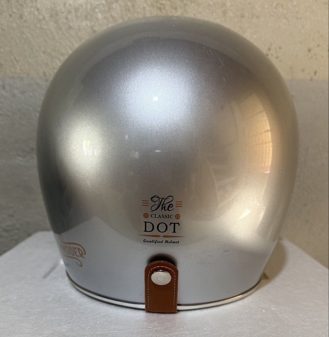 Moder Classic Dot Motorcycle Helmet Silver (Category: Bicycles) located in Dasmarinas. Submitted by toyang50 (Listing ID 1466605311, Image 2). Description: Silver retro motorcycle helmet from Moder. Classic DOT certified design with a brown tinted visor. Interior lined with tan quilted padding and brown leather trim. Chin strap includes a D-ring and quick-release buckle. Clean inner lining and shiny outer shell. Great choice for vintage bike ride