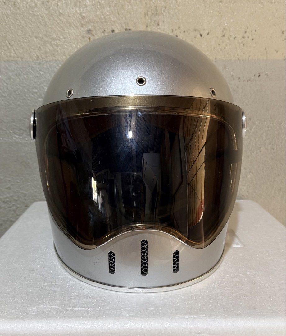 Moder Classic Dot Motorcycle Helmet Silver (Category: Bicycles) located in Dasmarinas. Submitted by toyang50 (Listing ID 1466605311, Image 1). Description: Silver retro motorcycle helmet from Moder. Classic DOT certified design with a brown tinted visor. Interior lined with tan quilted padding and brown leather trim. Chin strap includes a D-ring and quick-release buckle. Clean inner lining and shiny outer shell. Great choice for vintage bike ride