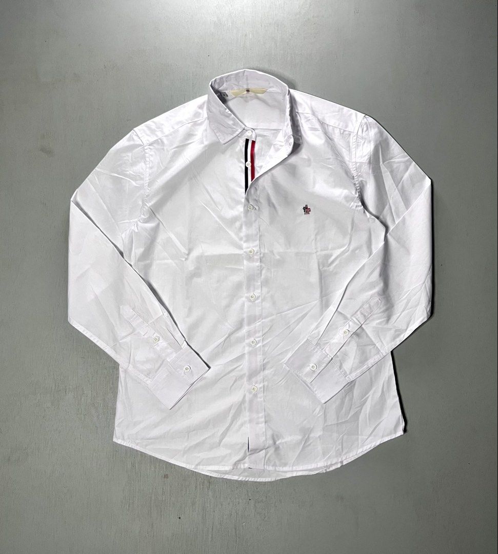 Moncler White Long Sleeve Button Down Shirt Size 3 (Category: Longsleeves) located in Catbalogan. Submitted by yellfindss (Listing ID 1466744323, Image 3). Description: Moncler long sleeve button down shirt in white. Classic collar, front button closure with red, white, and blue placket trim. Small Moncler logo embroidered on the left chest. Tag size 3 indicated on the collar label. Clean cotton fabric, nice tailoring throughout. -22.5/29.